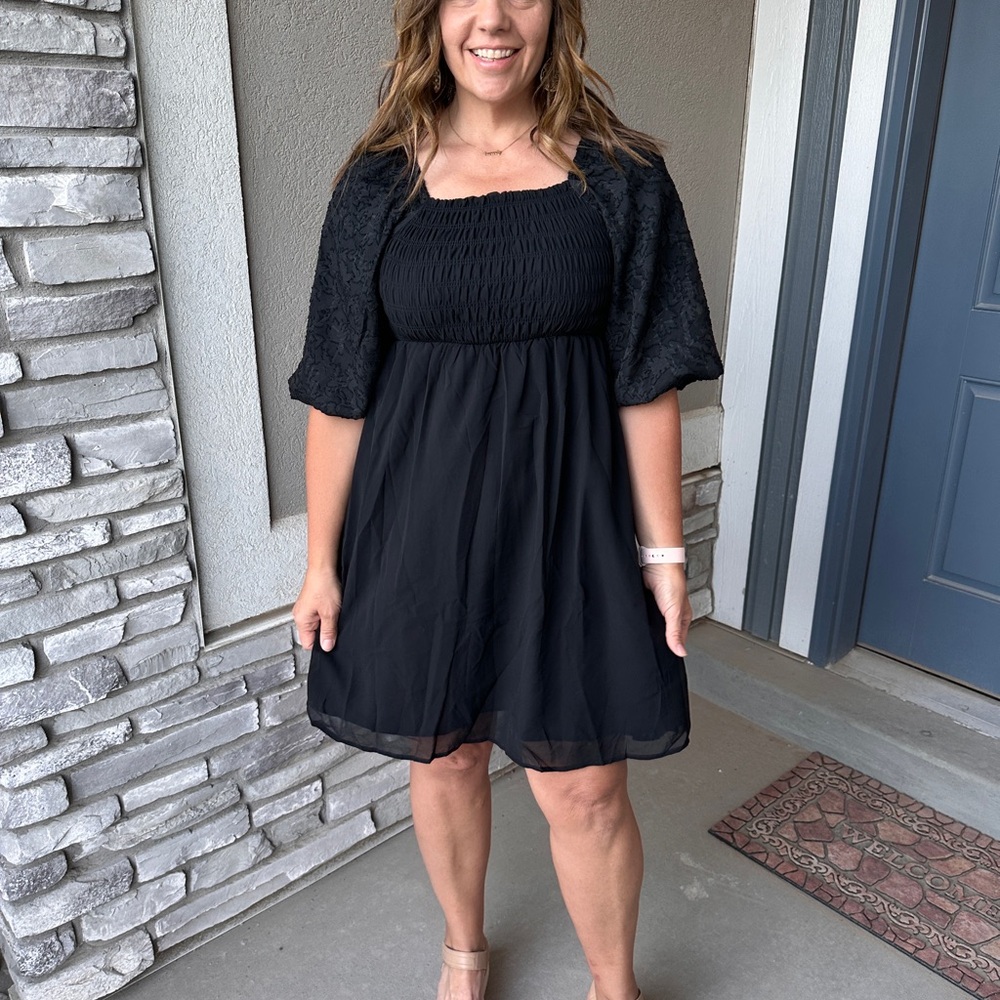 Black chiffon dress with smocked bodice.